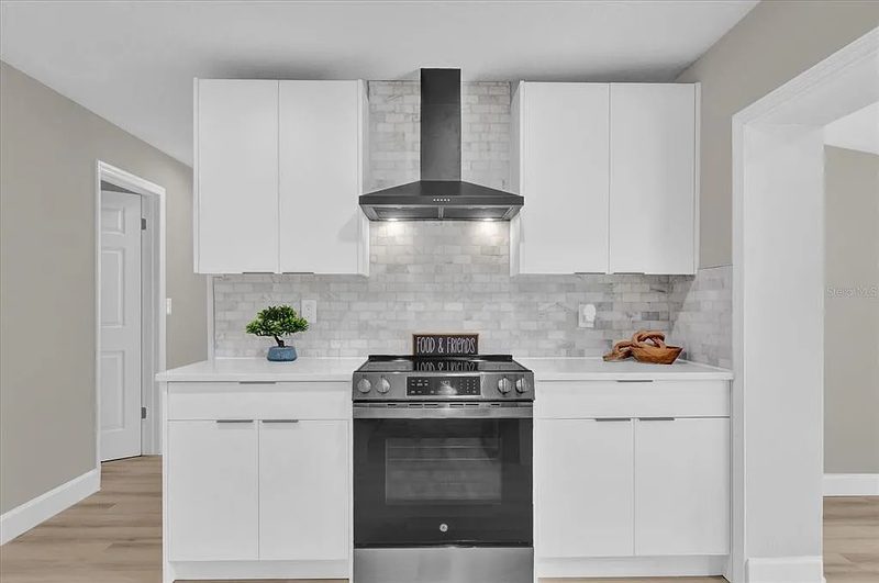 Refined kitchen with custom white cabinetry