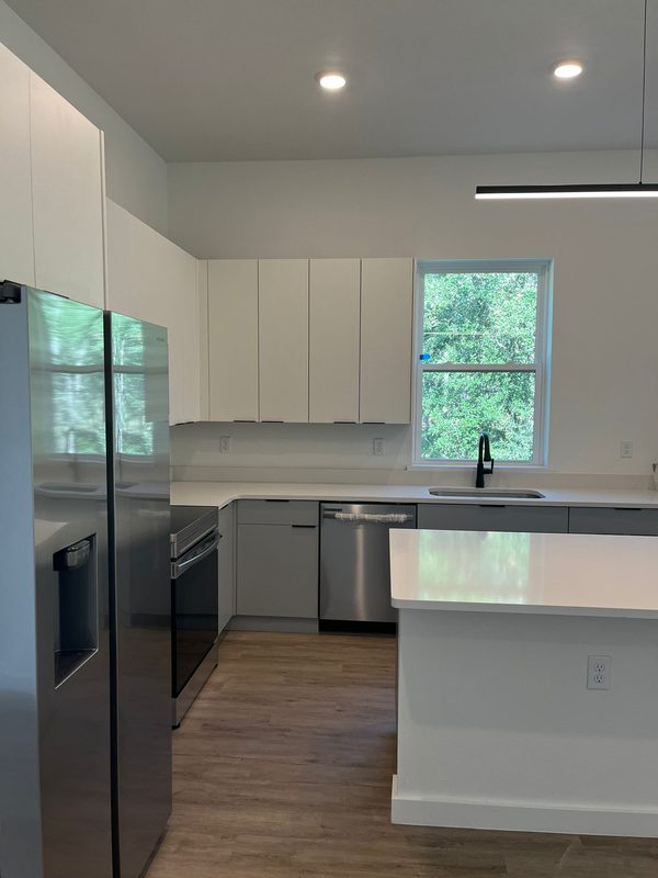 Contemporary kitchen with custom white cabinetry