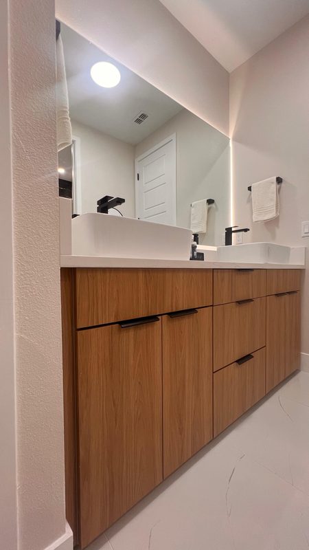 Modern bathroom with walnut vanity cabinetry