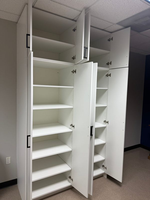 Spacious closet with white built-in shelving