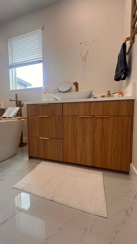 Polished bathroom with warm wood vanity
