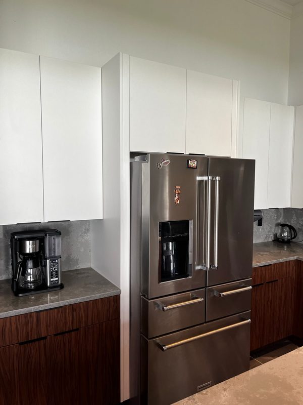 Contemporary kitchen with mixed material cabinetry
