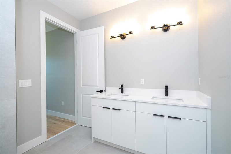 Elegant primary bathroom with dual vanity