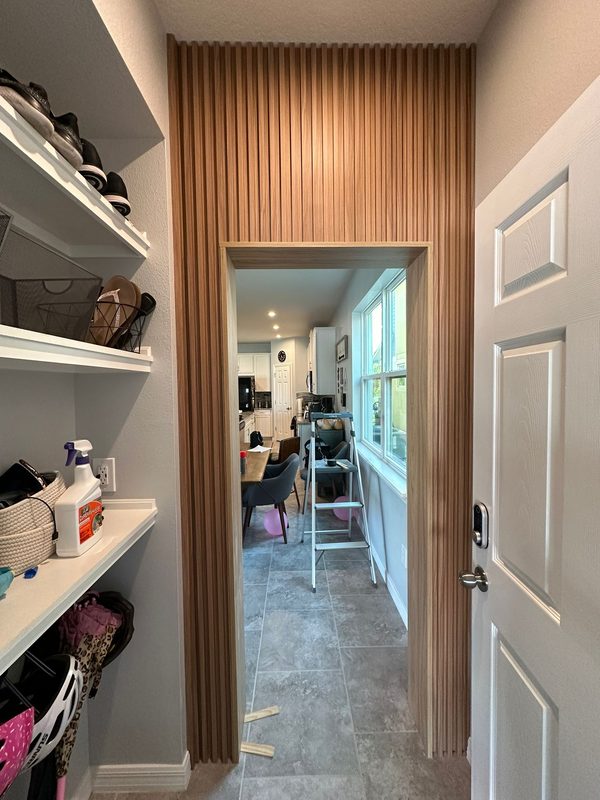 Elegant closet with vertical wood paneling
