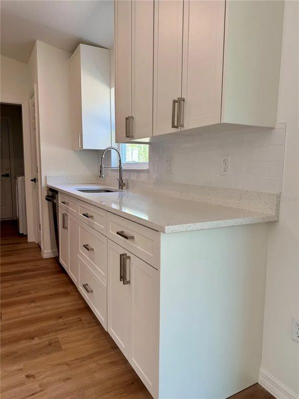 Contemporary kitchen with custom white cabinetry