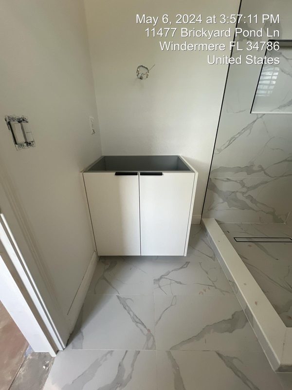 Bright bathroom with compact white cabinetry