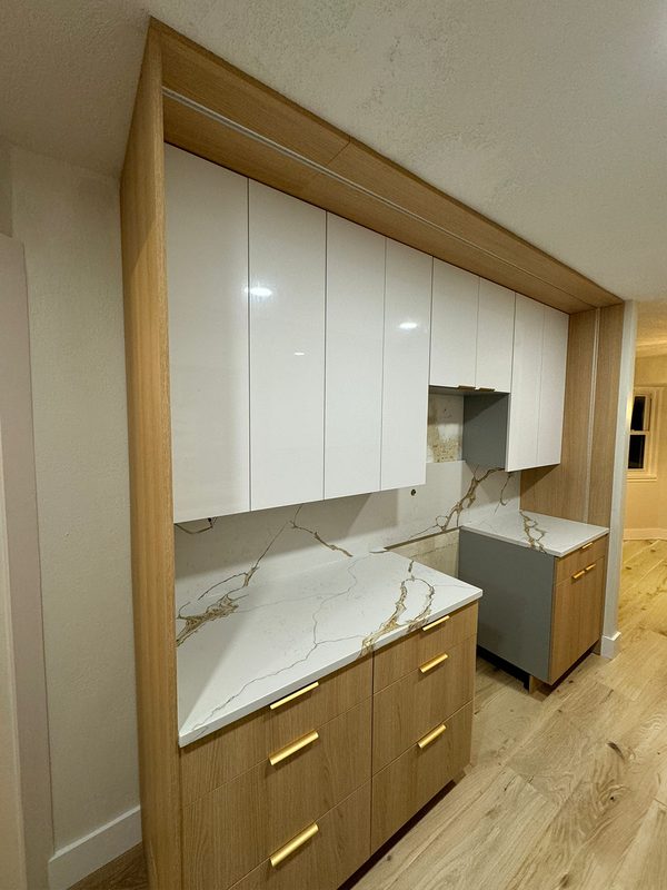Two-tone kitchen with brass hardware accents