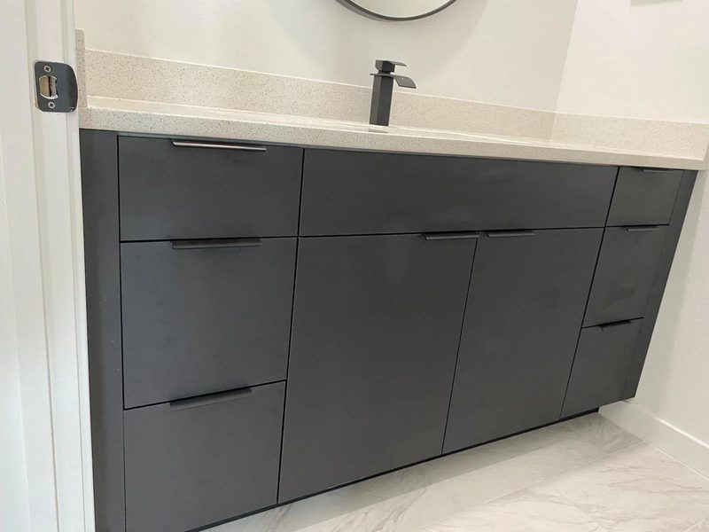 Elegant bathroom with charcoal cabinetry