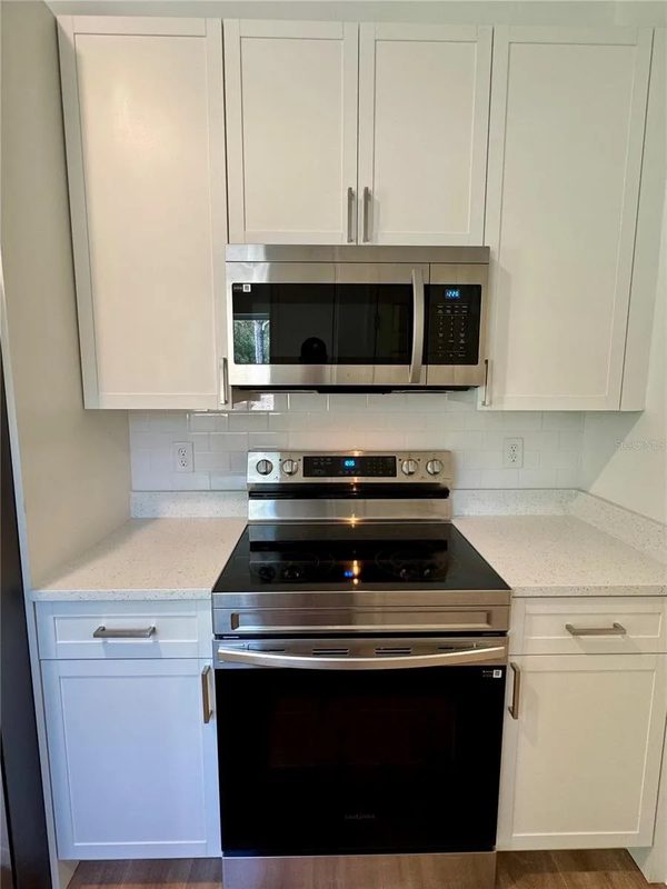 Contemporary kitchen with custom white cabinetry