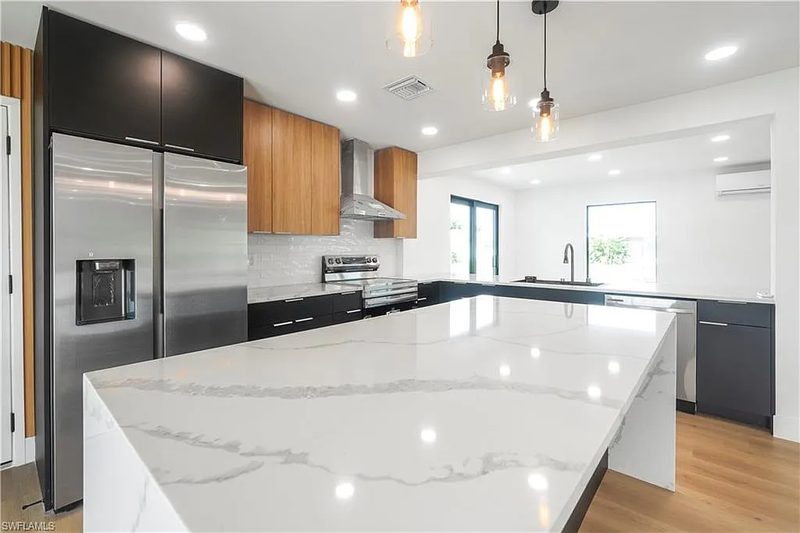 Contemporary Kitchen with Marble Island Waterfall Edge