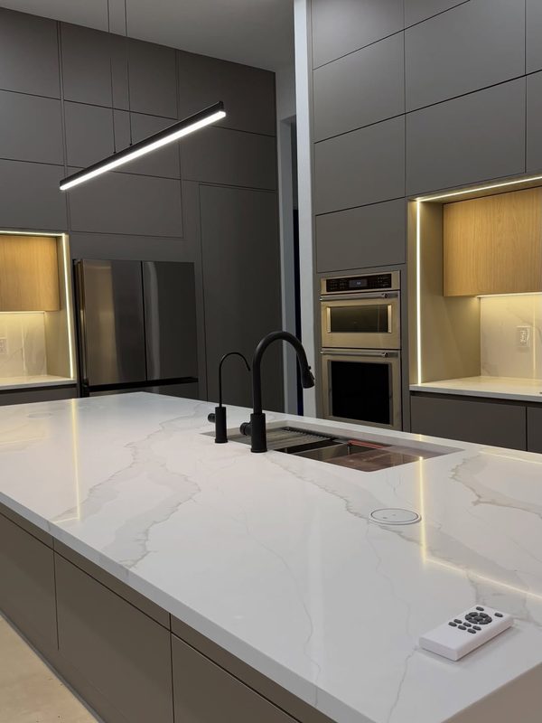 Contemporary kitchen with marble waterfall island