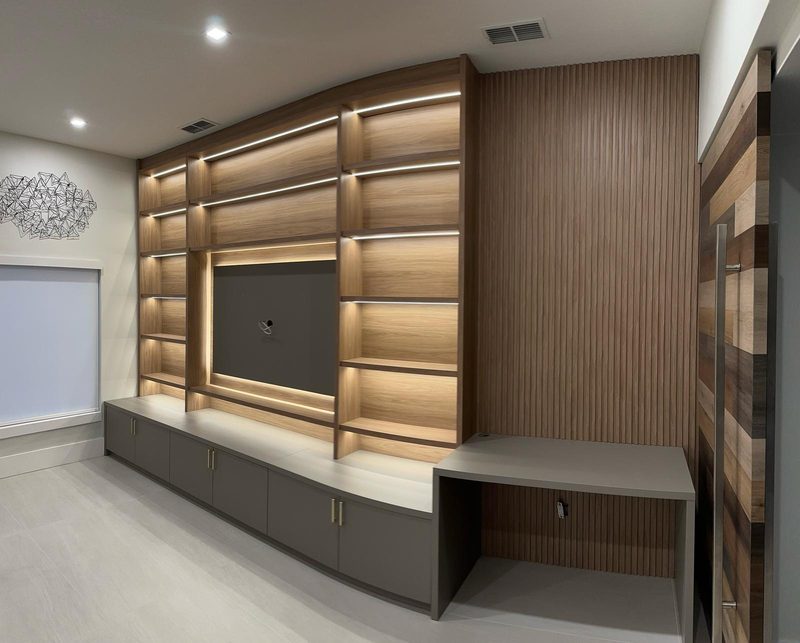 Modern media room with illuminated cabinetry