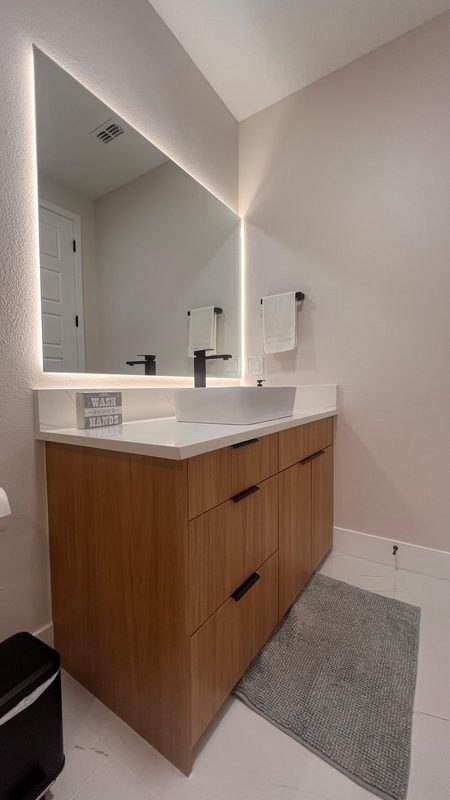 Modern bathroom with illuminated mirror vanity