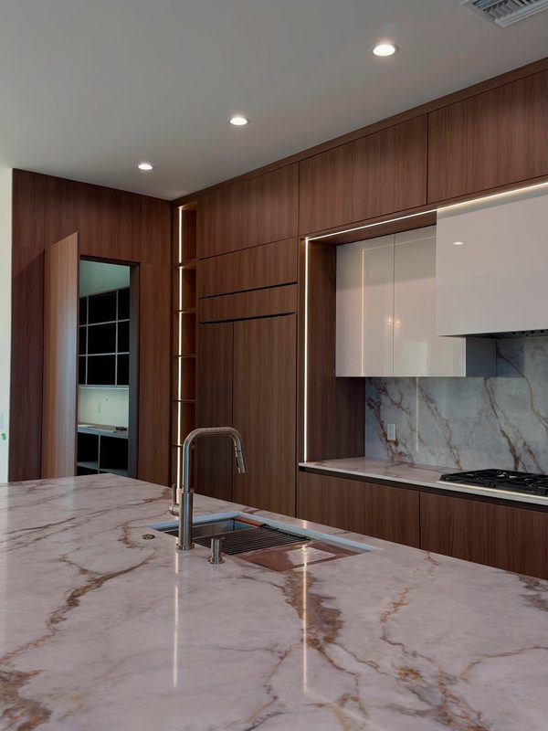 Contemporary kitchen with walnut cabinetry