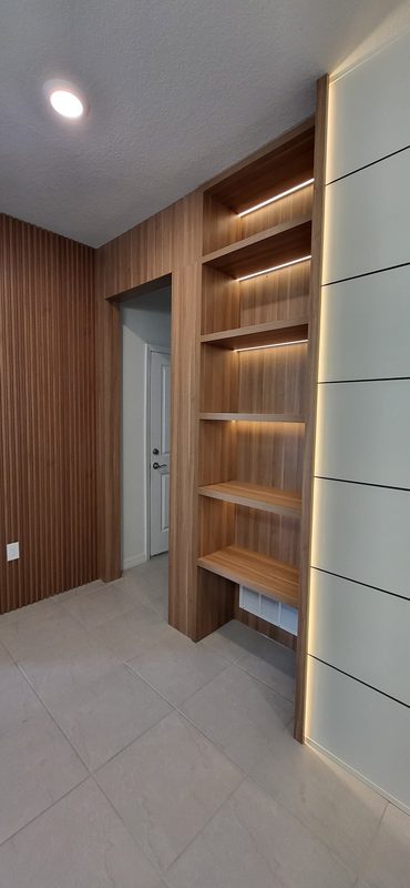 Modern entryway with custom wood shelving