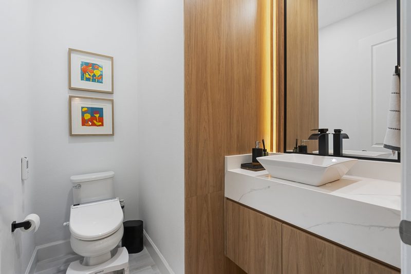 Elegant bathroom with warm wood cabinetry