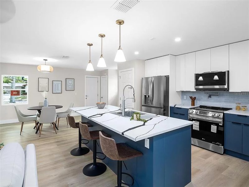 Contemporary kitchen with custom blue cabinetry