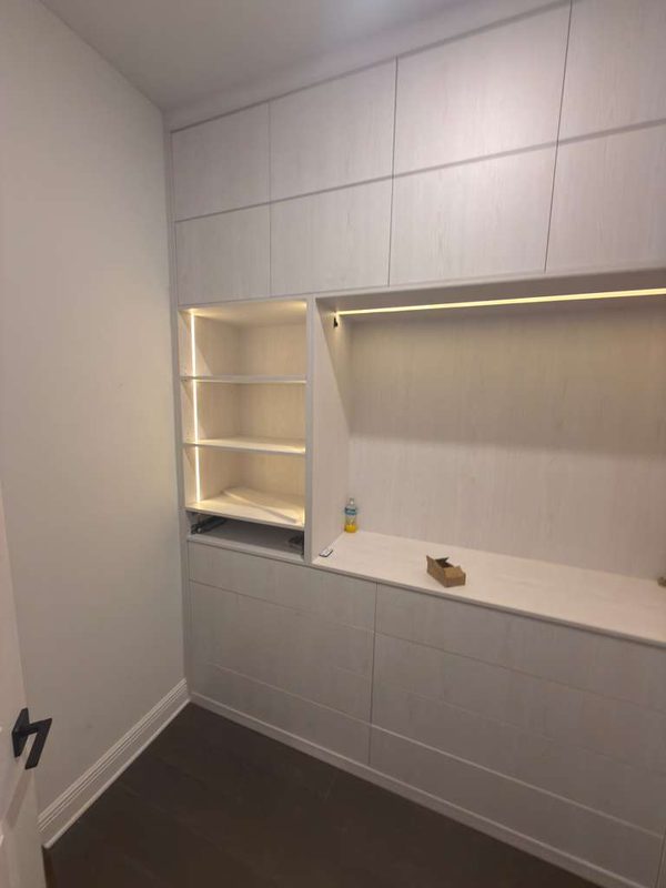 Sleek closet with floor-to-ceiling cabinetry