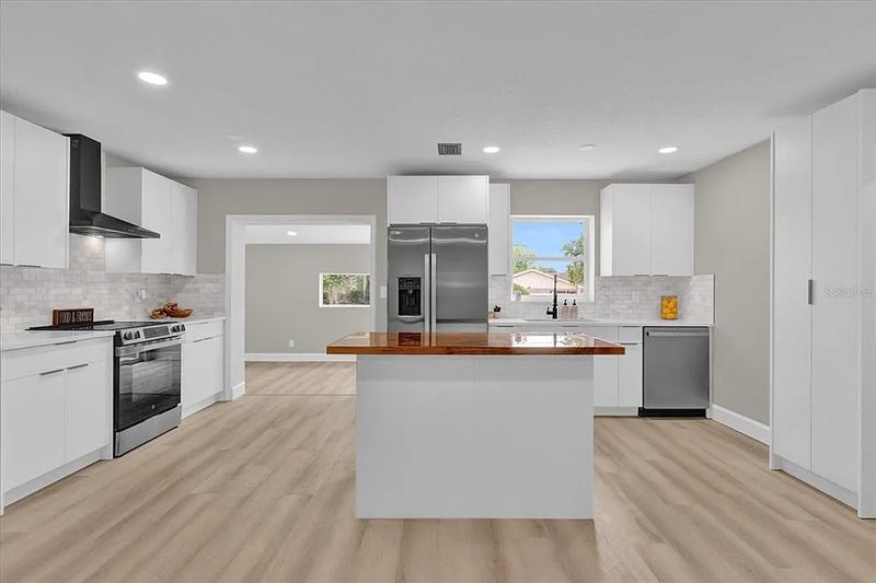 Contemporary kitchen with custom white cabinetry