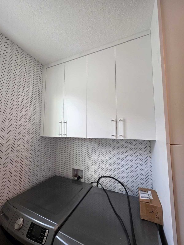 Polished laundry with custom cabinetry