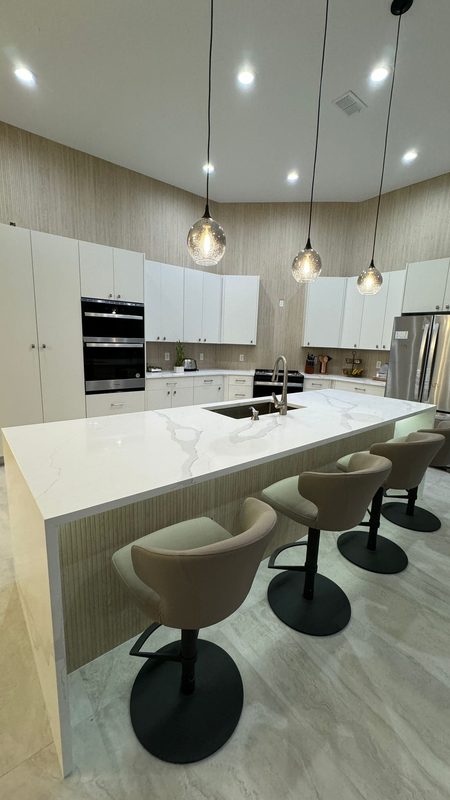 Contemporary kitchen with waterfall island countertop