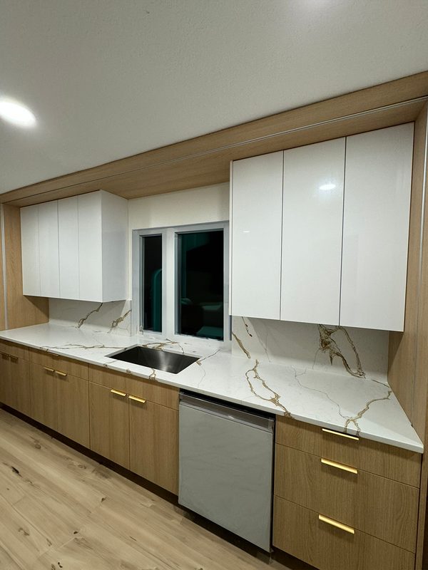 Contemporary kitchen with marble waterfall counters