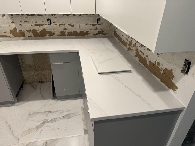 Crisp kitchen with white quartz countertops