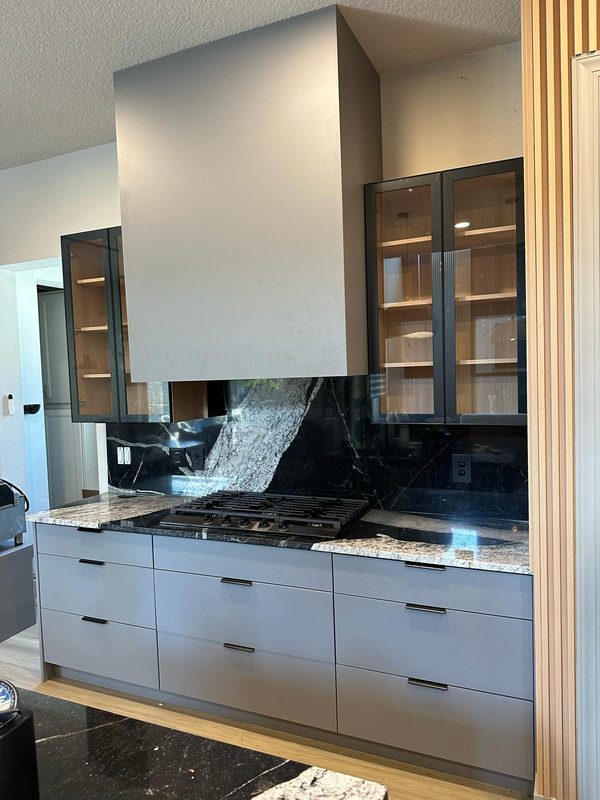 Contemporary kitchen with marble waterfall island