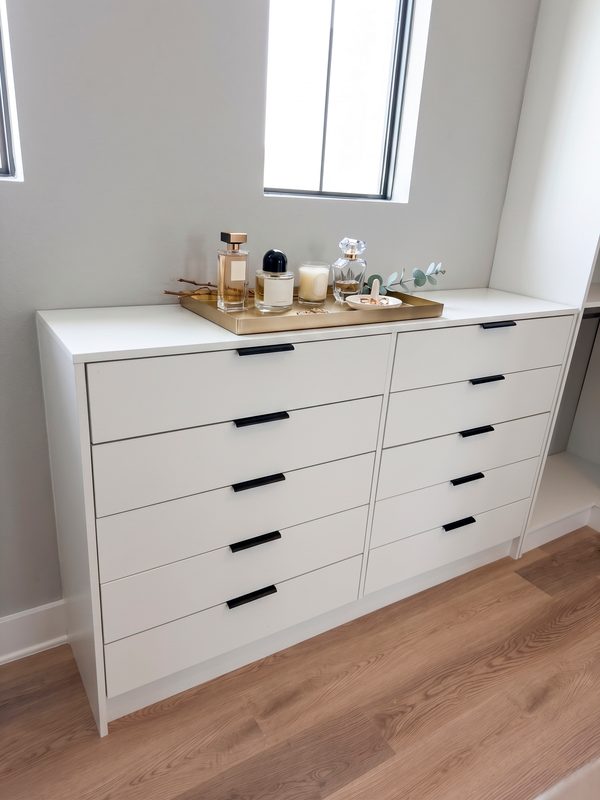 Elegant closet with white built-in drawers