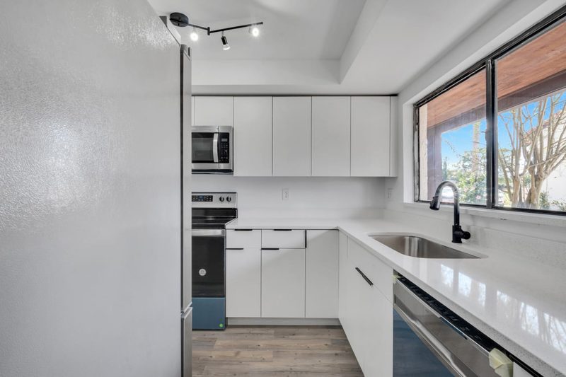 Contemporary kitchen with custom white cabinetry