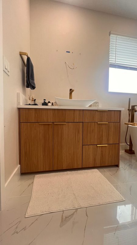 Elegant bathroom with warm wood cabinetry