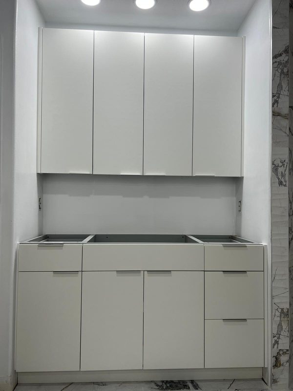 Compact kitchen with sleek white cabinetry