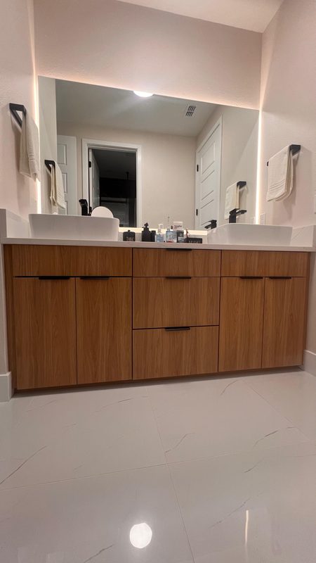 Elegant bathroom with walnut vanity cabinetry