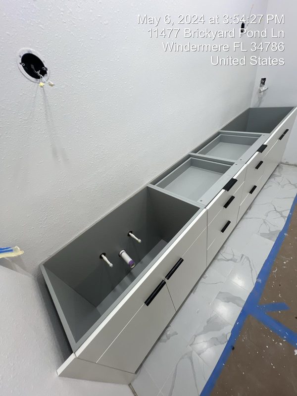 Streamlined bathroom with gray vanity cabinetry