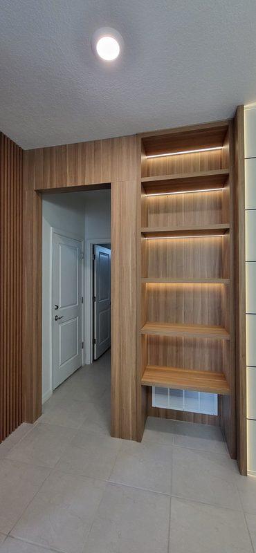 Elegant entryway with custom wooden shelving